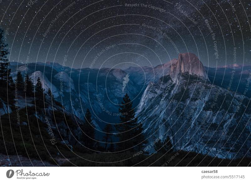 Scenic night sky above the famous Half Dome mountain, Yosemite NP yosemite half dome national park stars forest blue evening landscape climbing long exposure