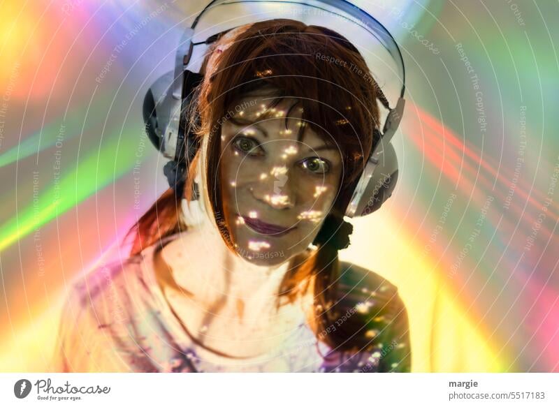 A woman with headphones listens to music Woman Headphones portrait Lifestyle Listening Smiling Prismatic colors Shadow Light Light (Natural Phenomenon)