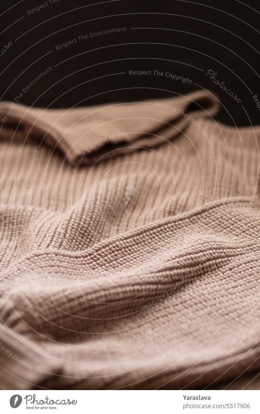 photo of a knitted brown sweater close-up textile textured warm clothing material design fashion background winter cotton pattern wool autumn craft horizontal