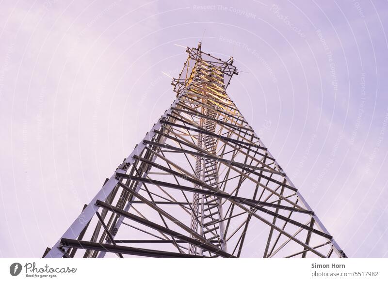 Transmission tower with setting sun Steel construction Pole Broadcasting tower Tower radio mast Construction Ladder Sky Manmade structures Communication