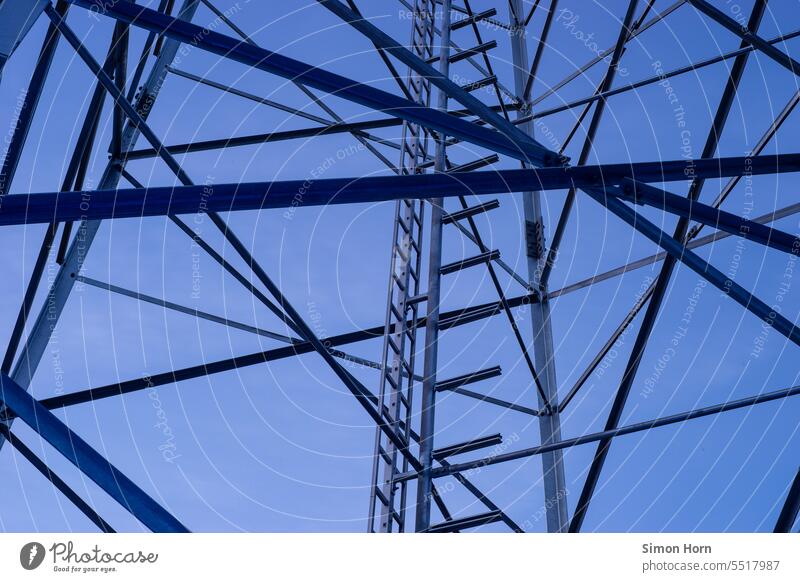 Steel structure of a transmission tower in front of evening sky Steel construction Pole Broadcasting tower Tower radio mast Construction Ladder Sky