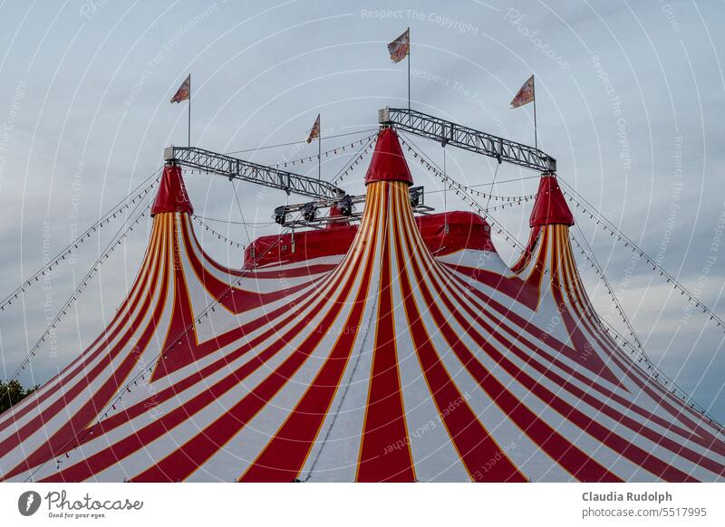 Roof of red and white striped circus tent with waving flags Circus Circus tent Zikus tents Tent Sky Shows Event Culture Fairs & Carnivals Point