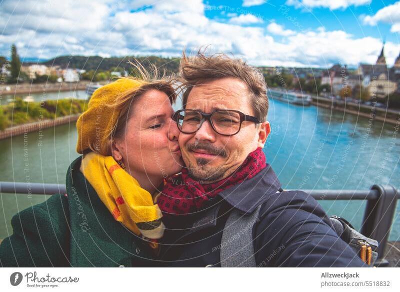 Couple taking selfie in autumn weather and strong wind while she kissing him Germany Koblenz Selfie Couples Middle aged couples Kissing windy windy weather Wind