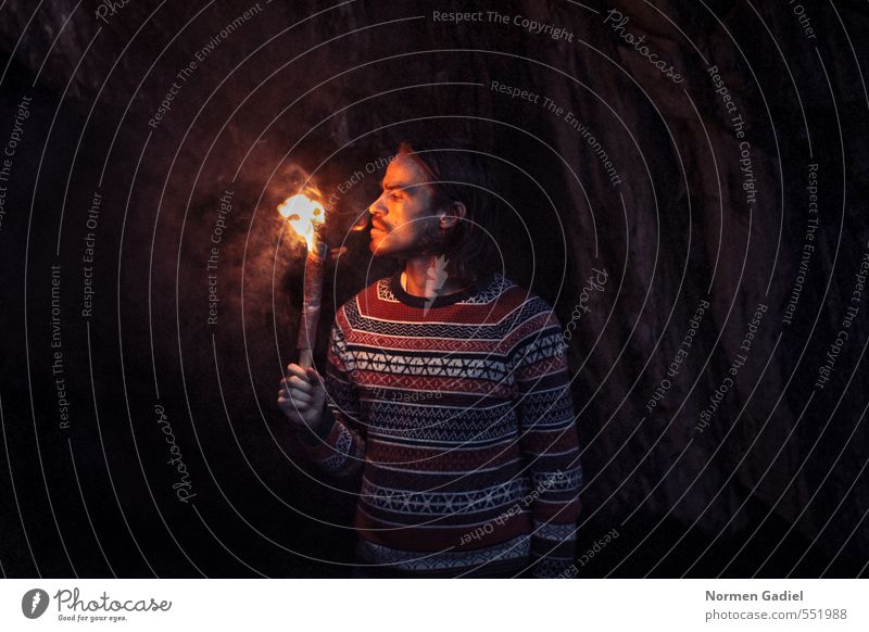 fiery Human being Young man Youth (Young adults) Man Adults 1 18 - 30 years Fire Rock Sweater Curiosity Warmth Cave Torch Discover Brave Search Light Dark Hot