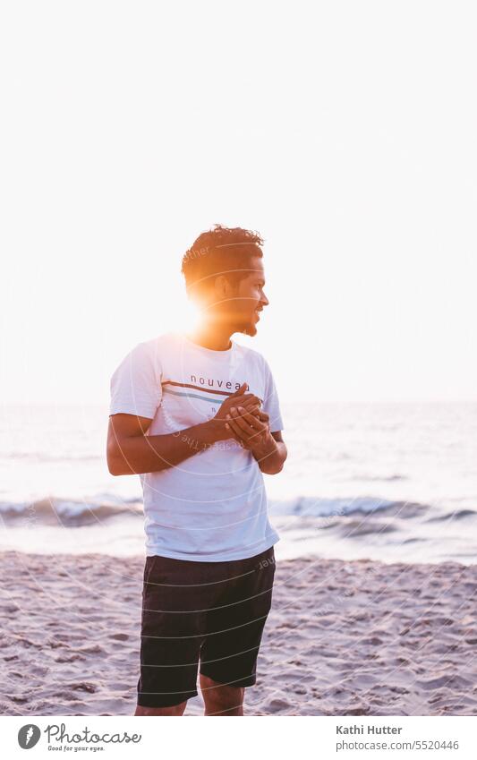 A young man by the sea with wind in his hair and the sunset. Man Sunlight Sunset Exterior shot Human being Adults Colour photo Young man Back-light Nature