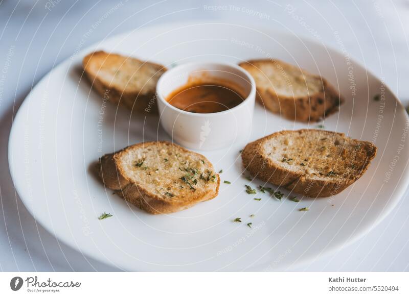 Garlic bread on a white plate with a small bowl of sauce in the middle garlic bread Eating Food Herbs and spices Fresh Ingredients Vegetable Colour photo