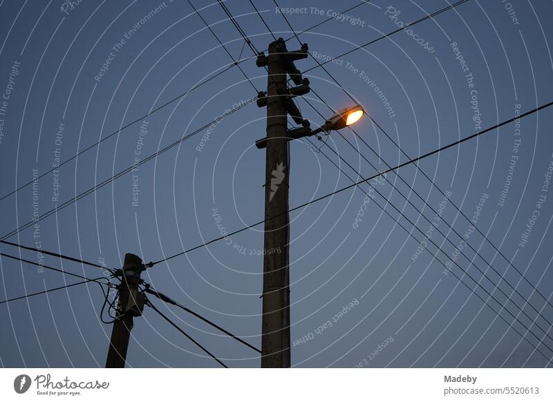 Power lines with street lighting on a line pole in the evening in the village of Maksudiye near Adapazari in Sakarya province, Turkey adapazari streetlamp