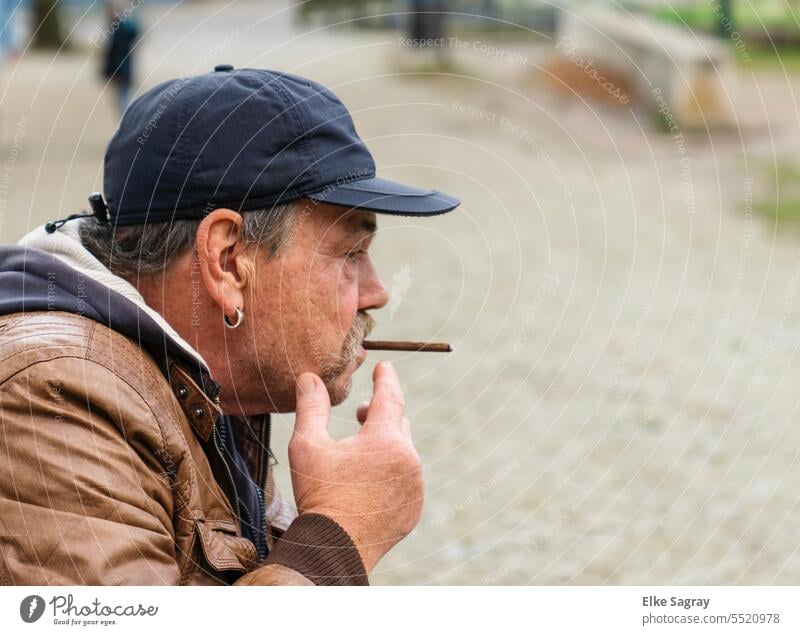 Lonely thoughtful man smoking cigarello Man Only one man portrait 1 Person Face of a man One young adult man Contrast Sideways glance Exterior shot Masculine