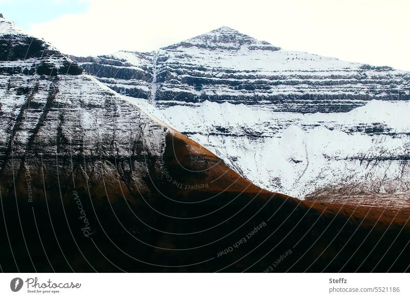 Faroe Islands with snowy peaks färöer Sheep Islands Rock spectacular Rock mound Rock face rocky shore Hill Hill side Steep Snow layers snow-covered mountain