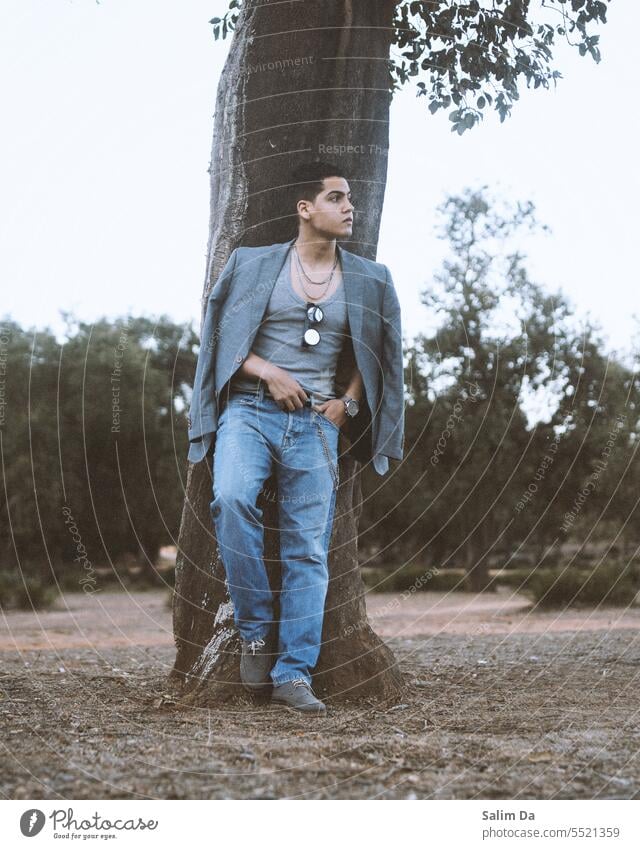 Young handsome man in a stylish trendy outfit. Forest photography Jeans Denim denim jeans Denim blue Vest blazer grey Clothing Fashion young adult Young man