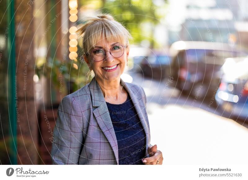 Portrait of smiling senior businesswoman in the city natural enjoy satisfied cheerful confident pensioner outdoors outside eyeglasses elderly happiness older