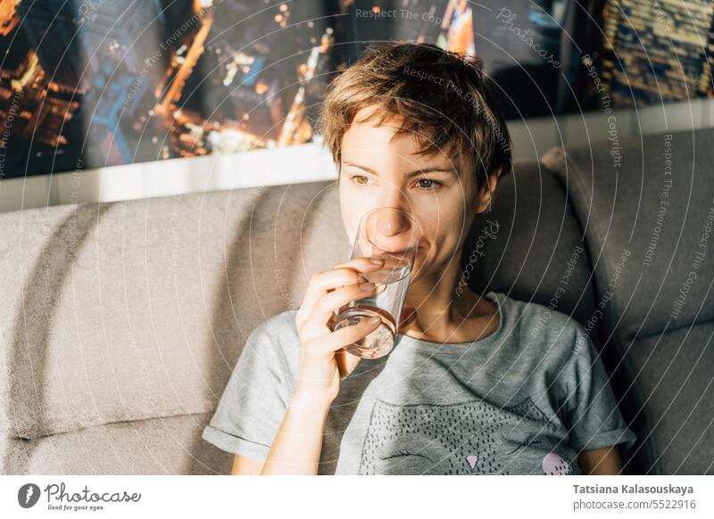 Portrait of a short-haired young woman drinking water from a glass female Domestic life people Drink person Drinking caucasian Glass 30-40 years Dishes