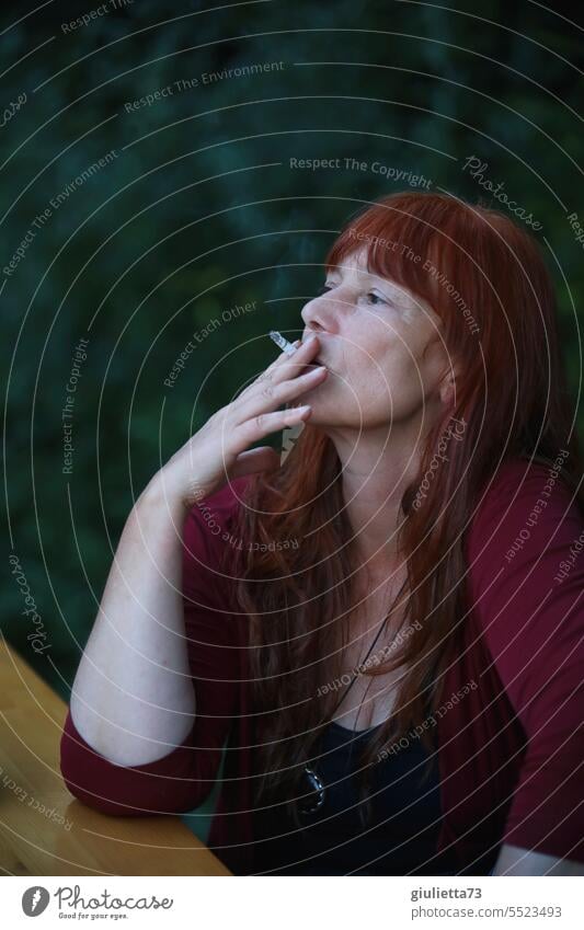 Drinkje bej Inkje | Smoking break, woman with long red hair takes a pleasurable drag on her cigarette portrait Woman Middle aged women Long-haired Smoker