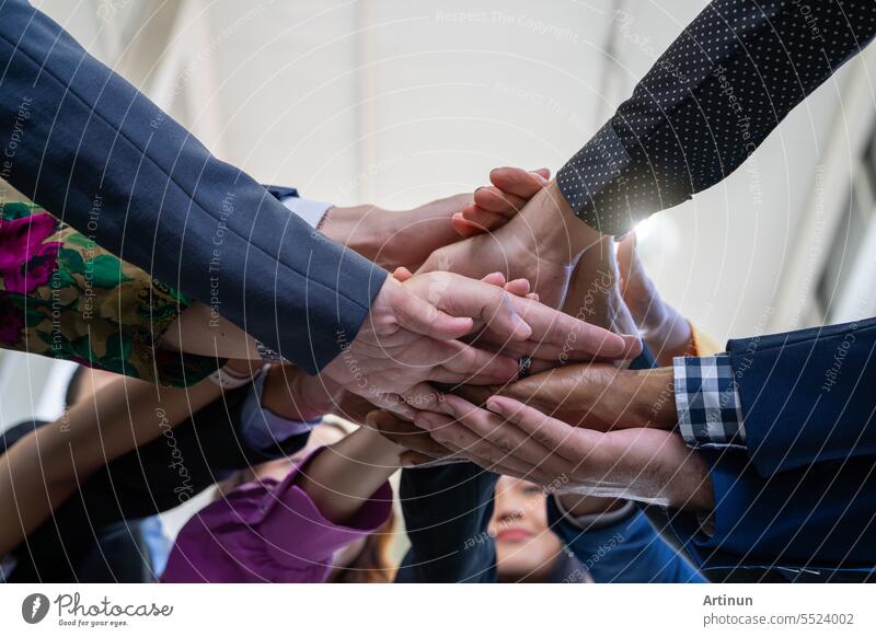 Team, teamwork, and unity concept. Diverse team putting hands together. Group of diverse business people. Working together as a team. Partnership and togetherness create a strong sense of community.