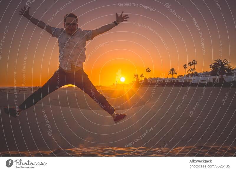 middle-aged man jumping in the dunes of MasPalomas on Gran Canaria at sunset Azores Island vacation Vacation photo Vacation destination Vacation mood Summer