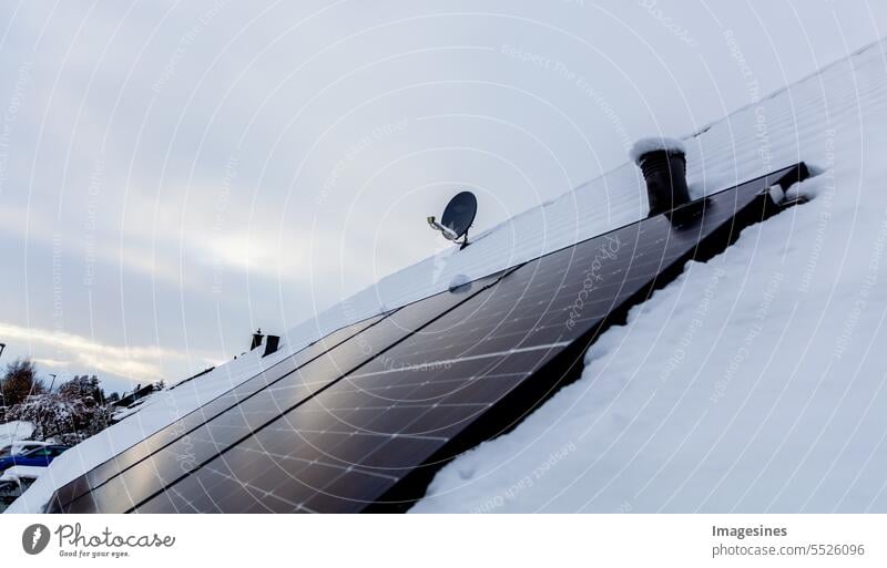 Solar panels on the roof with snow in winter solar collectors Roof Snow Winter. snow removal photovoltaic system Solar cells Panels stream Energy efficiency