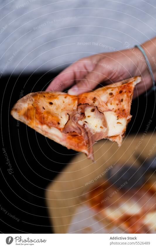 Unrecognizable person holding delicious pizza slice in hand baked tomato food piece tasty meal yummy fresh appetizing homemade italian cuisine palatable