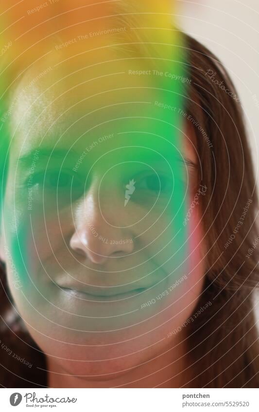 colorful gradient in front of face of smiling woman. tolerance, openness. Color gradient Face Woman Smiling Funny variegated Movement Rainbow queer