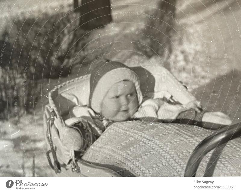 Analogue photograph 1943 little girl in baby carriage Kinderwages Black & white photo children's photo Child Eyes Mouth Looking Head portrait Cute