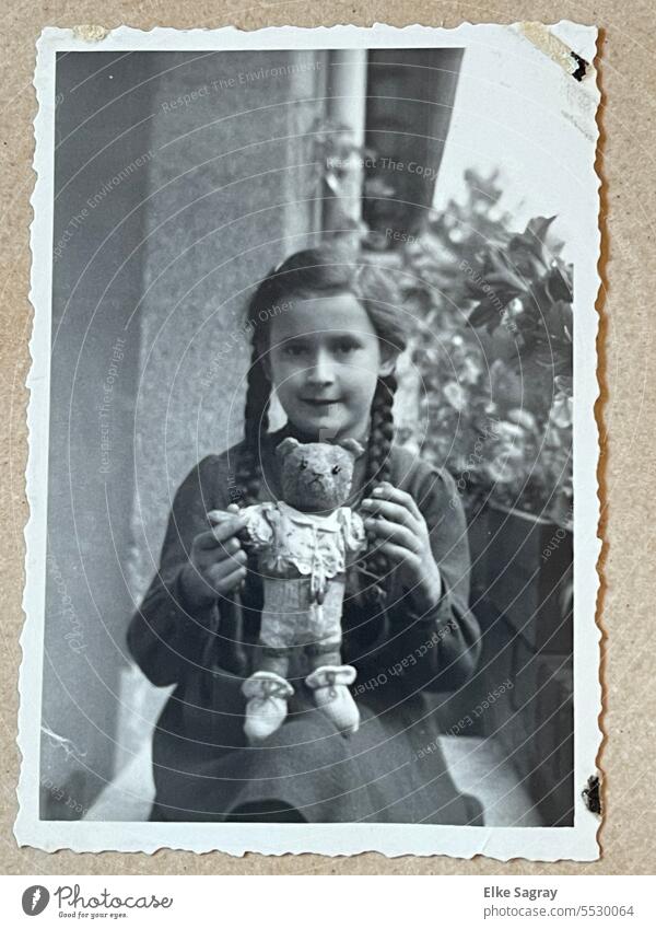 Analogue photography 1949 little girl with pigtails and teddy bear old photo Past Black & white photo Memory Photography Nostalgia Childhood memory Emotions