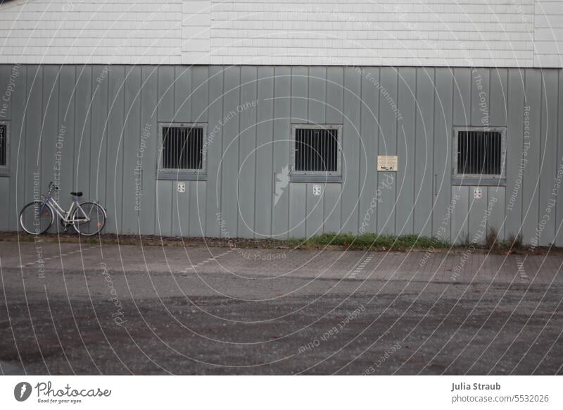 Wide land | Bicycle in the parking lot of the comets home away from home Parking lot Stand Ajar Window barred windows Aluminium Facade Exterior shot Building