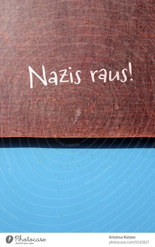 nazis out! says brown sign on blue wall Nazis Anti-fascism anti-fascist Protest Against Brown Blue National socialism Fascism right-wing extremism far-right
