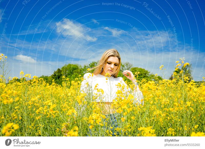 Young blonde woman in canola field Woman youthful Blonde Canola Canola field Freedom portrait Yellow Field Nature Summer Spring Blossoming Plant Environment