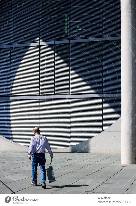 Someone with a Bundestag bag walks through the government district of Berlin Pouch Government offices authorities Building government quarter Capital city