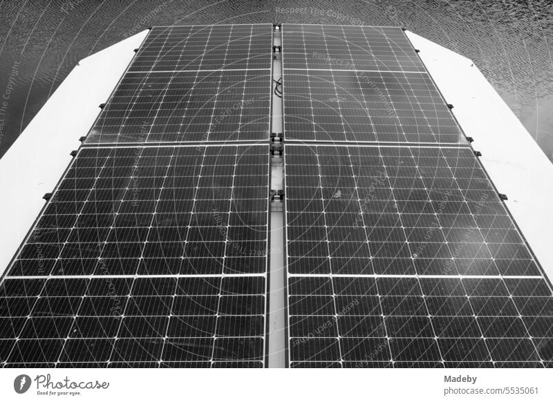 Modern photovoltaic on the roof of a houseboat in summer in the marina on the Moselle between vineyards in Traben-Trarbach in Rhineland-Palatinate in Germany in classic black and white