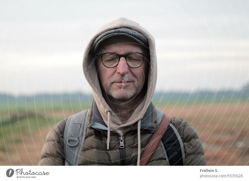 Wide land | dreamlike portrait Closed eyes masculine Hooded (clothing) Cold Landscape Jacket Ruclsack Horizon