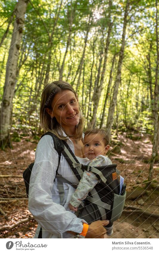 Woman with her 7-month-old baby in the forests of the Pyrenees active adventure autumn beautiful boy caucasian cheerful child childhood cute daughter family