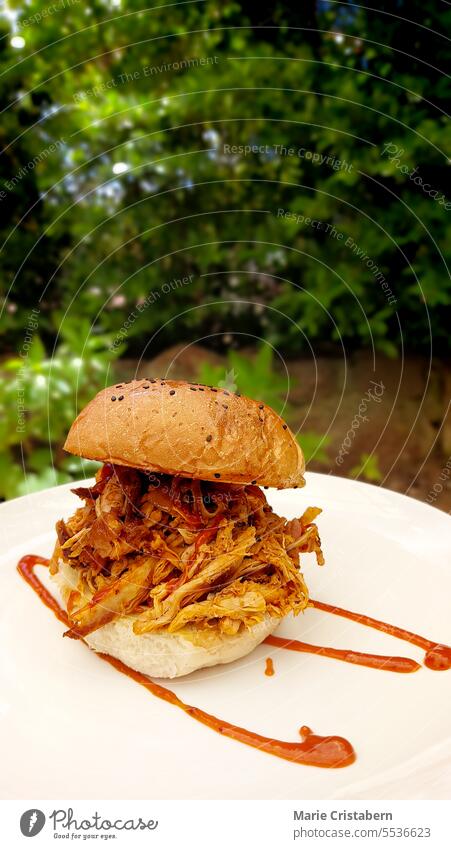 Close up to a smoked pulled pork burger in a tropical summer resort close up vertical relaxing unwinding holiday vacation food snack travel nobody lifestyle