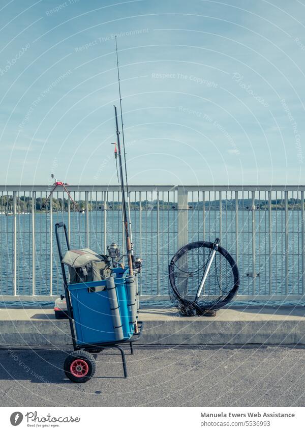 Anglers have set up their equipment on a pier. fish Fisherman fishing fishing equipment gear Fishing (Angle) angel Bridge Lake Water Body of water Blue troll