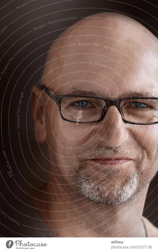 Wide middle parting with glasses with three day beard Man portrait Eyeglasses kind Smiling Looking into the camera Bald or shaved head Baldy Designer stubble