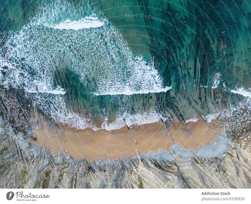 Drone shot of foamy water washing sandy beach sea wave nature coastline turquoise shore seaside ocean seascape seashore paradise summer scenic aerial basque