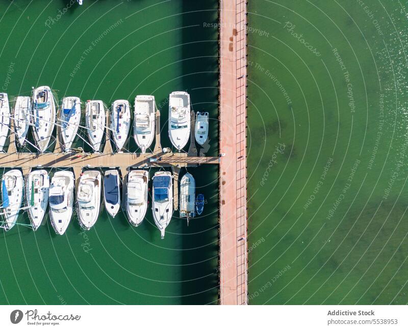 Boats moored near pier in green sea boat transport yacht vessel water row quay picturesque calm basque marine ocean height ship serene seawater scenic seafront