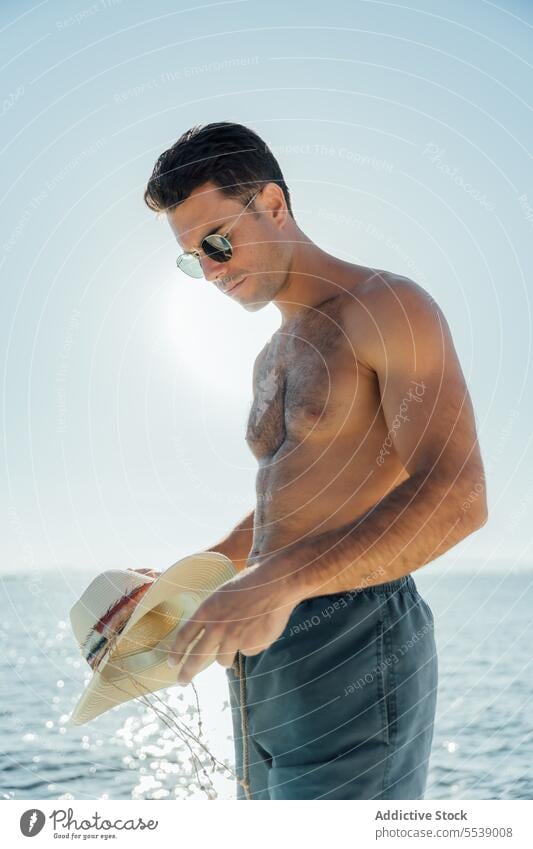 Handsome man on sailboat in the ocean yacht sensual summer vacation confident cruise body dreamer stylish vessel model outdoors male natural fit shirtless