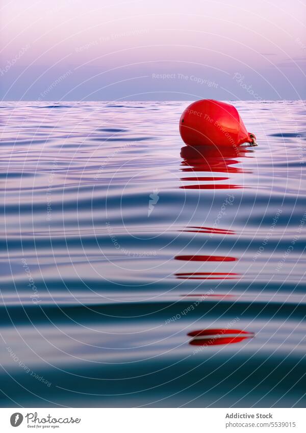 Red buoy on the sea during sunset red buoy maritime safety nautical sail ocean coast calm sundown nature transport seascape twilight dusk ripple danger wave