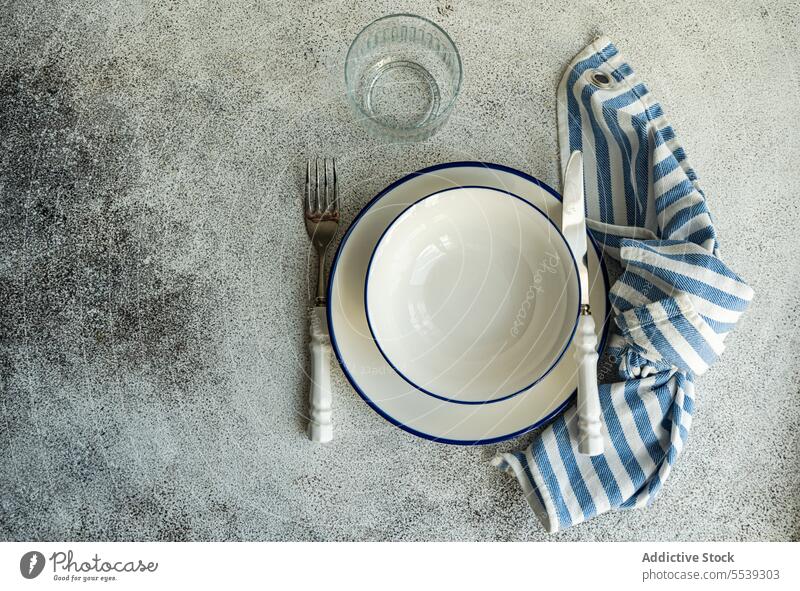 Minimalistic rustic table setting on gray surface plate napkin decor serve tableware dinnerware arrangement decoration utensil ceramic occasion creative