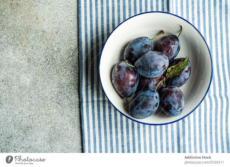 Ripe plums in bowl ripe juicy vegetarian purple food organic raw fresh natural harvest delicious refreshment freshness sweet colorful dessert plate snack