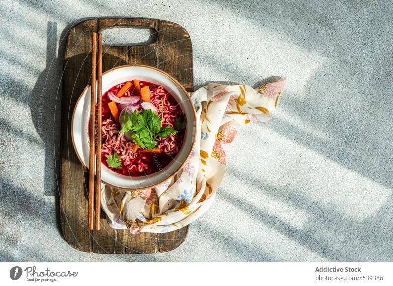 Bowl with beetroot soup with onion, coriander and noodles in Asian style pasta food cuisine sticks plate asian healthy meal traditional dinner gourmet tasty