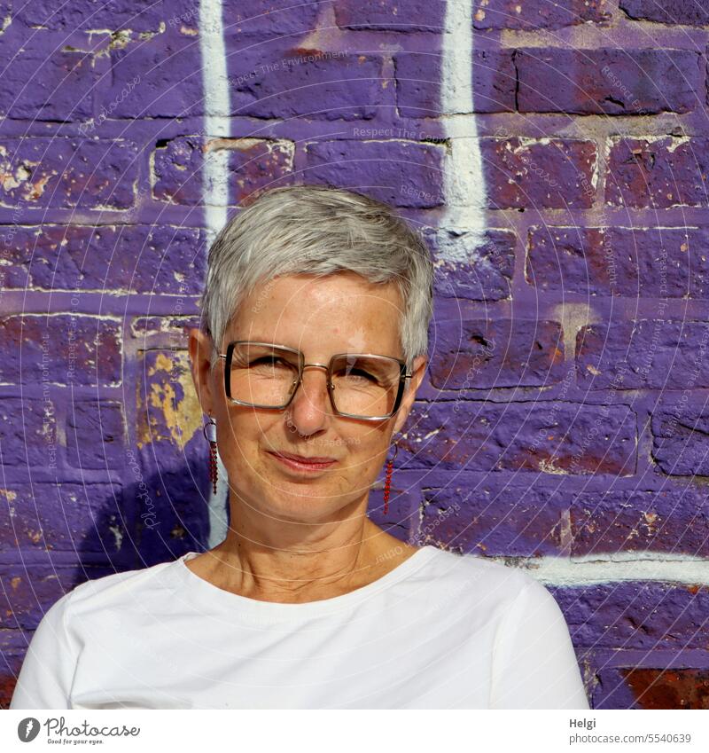 Wide land | portrait of pretty woman in front of purple painted brick wall Woman Head Face Short-haired Gray-haired Wall (building) Wall (barrier) Violet