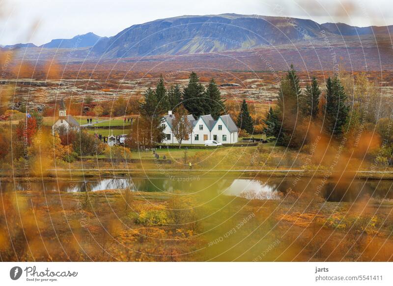 Four small houses and a church in Pingveilir National Park in Iceland Church Idyll Autumn autumn mood variegated mountain farsightedness Hiding place River Lake