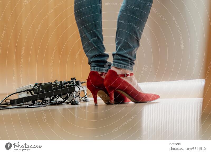 red pumps with blue jeans and stage technique on a stage Red red shoes Stage Effect device mixer stage technology Footwear Legs Feet Woman High heels Stand