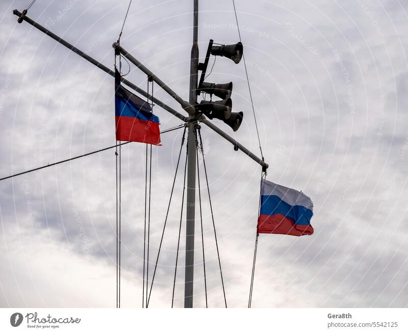 flag of russia tricolor and bullhorn on the mast Russia blue flag of Russia loudspeaker mouthpiece notification red sky symbol tricolor flag white
