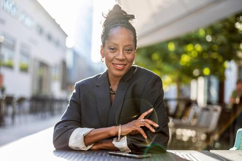 Portrait of a mature businesswoman sitting in an outdoor cafe people downtown joy urban black natural attractive city black woman happiness street happy modern
