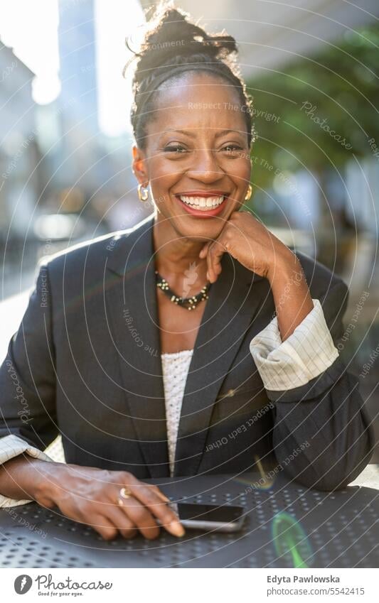 Portrait of a mature businesswoman sitting in an outdoor cafe people downtown joy urban black natural attractive city black woman happiness street happy modern