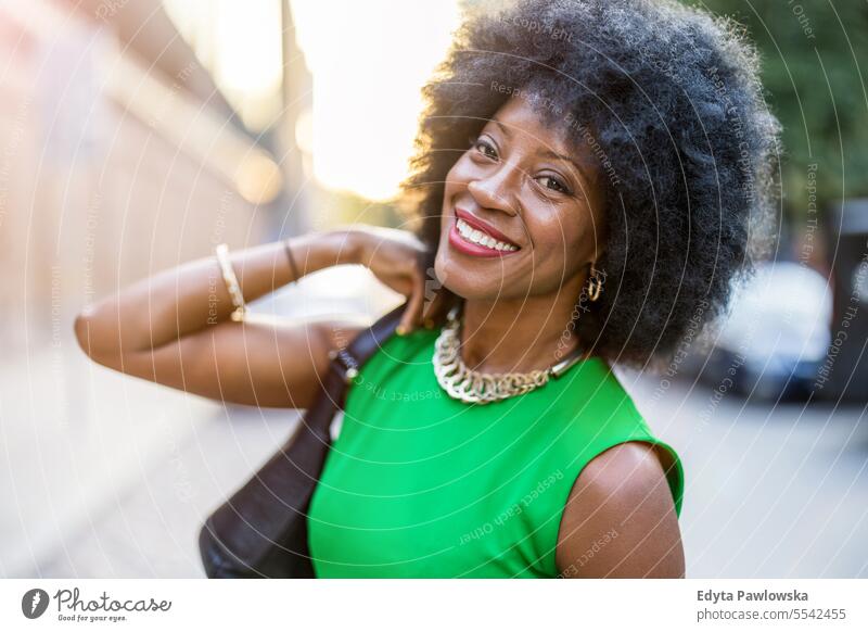 Portrait of a mature woman wearing green dress standing in the city people downtown businesswoman joy urban black natural attractive black woman happiness