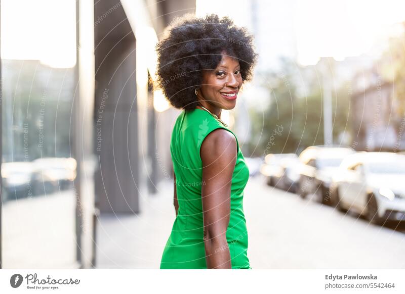 Portrait of a mature woman wearing green dress standing in the city people downtown businesswoman joy urban black natural attractive black woman happiness