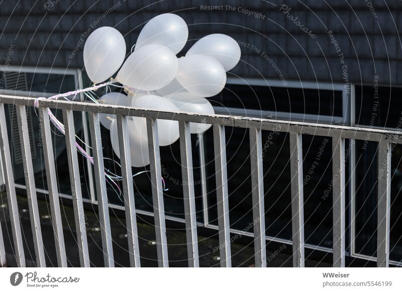 A cluster of white balloons hangs from the railing in front of the hotel celebrations Contrast Festive urban Town Fence Metal Hideous Office building Anonymous